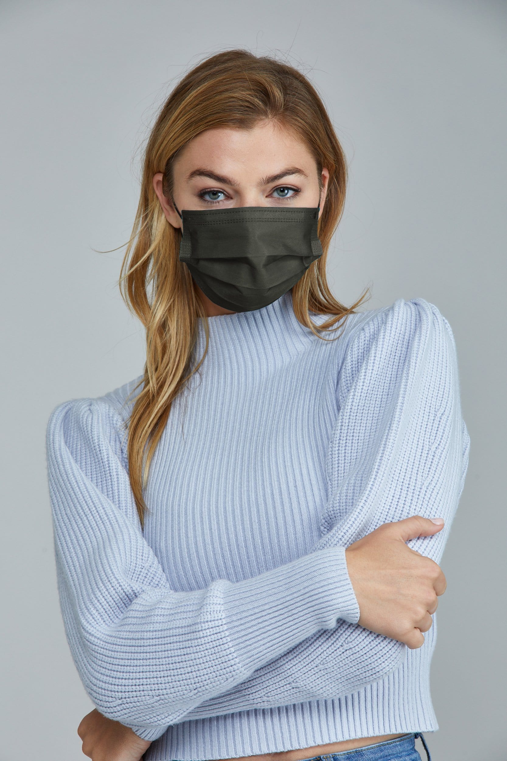 Woman wearing stylish Dark Green Pleated face mask, with three layers & high quality breathable fabric.