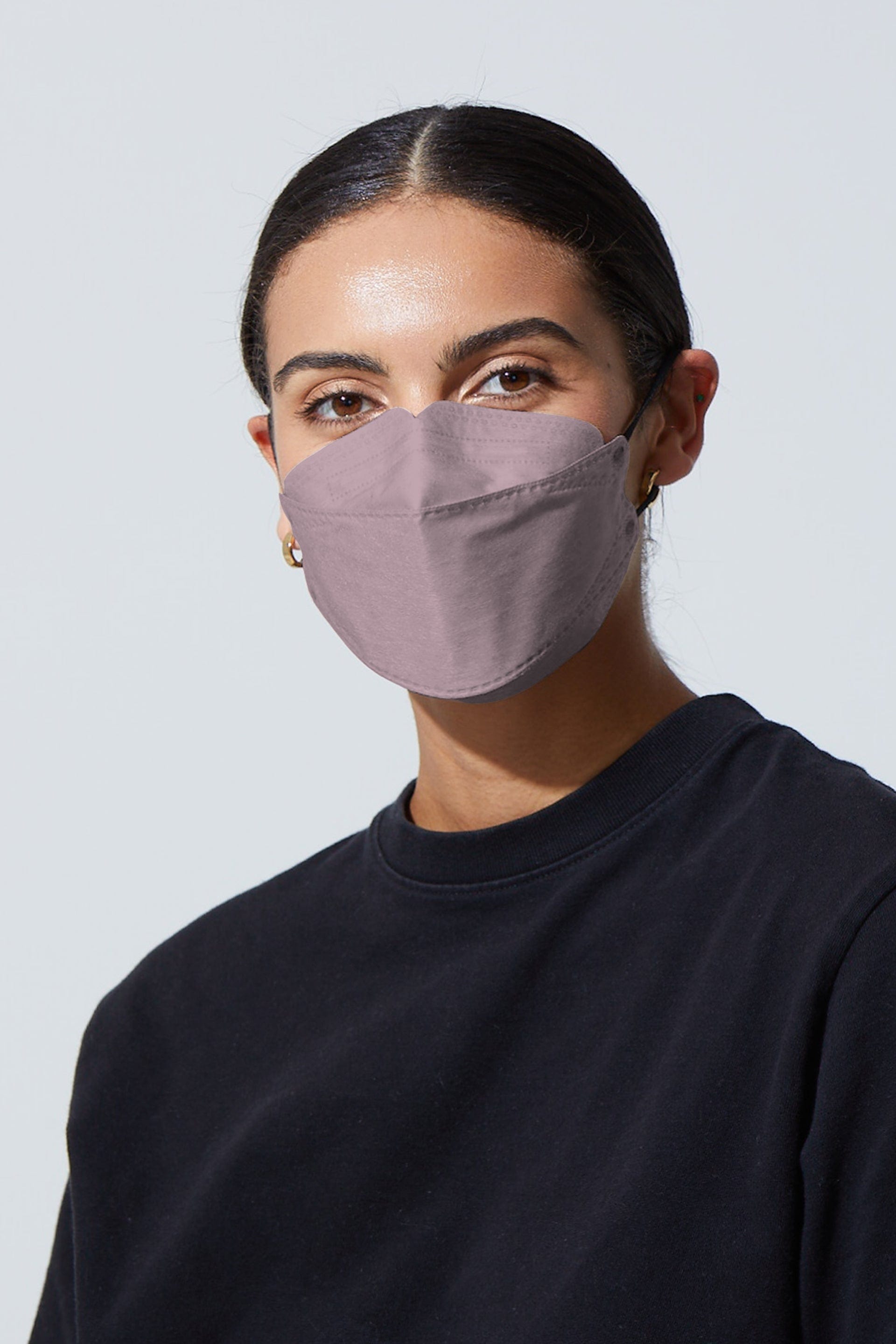 Woman wearing stylish Pink KF94 face mask, with high quality breathable fabric.