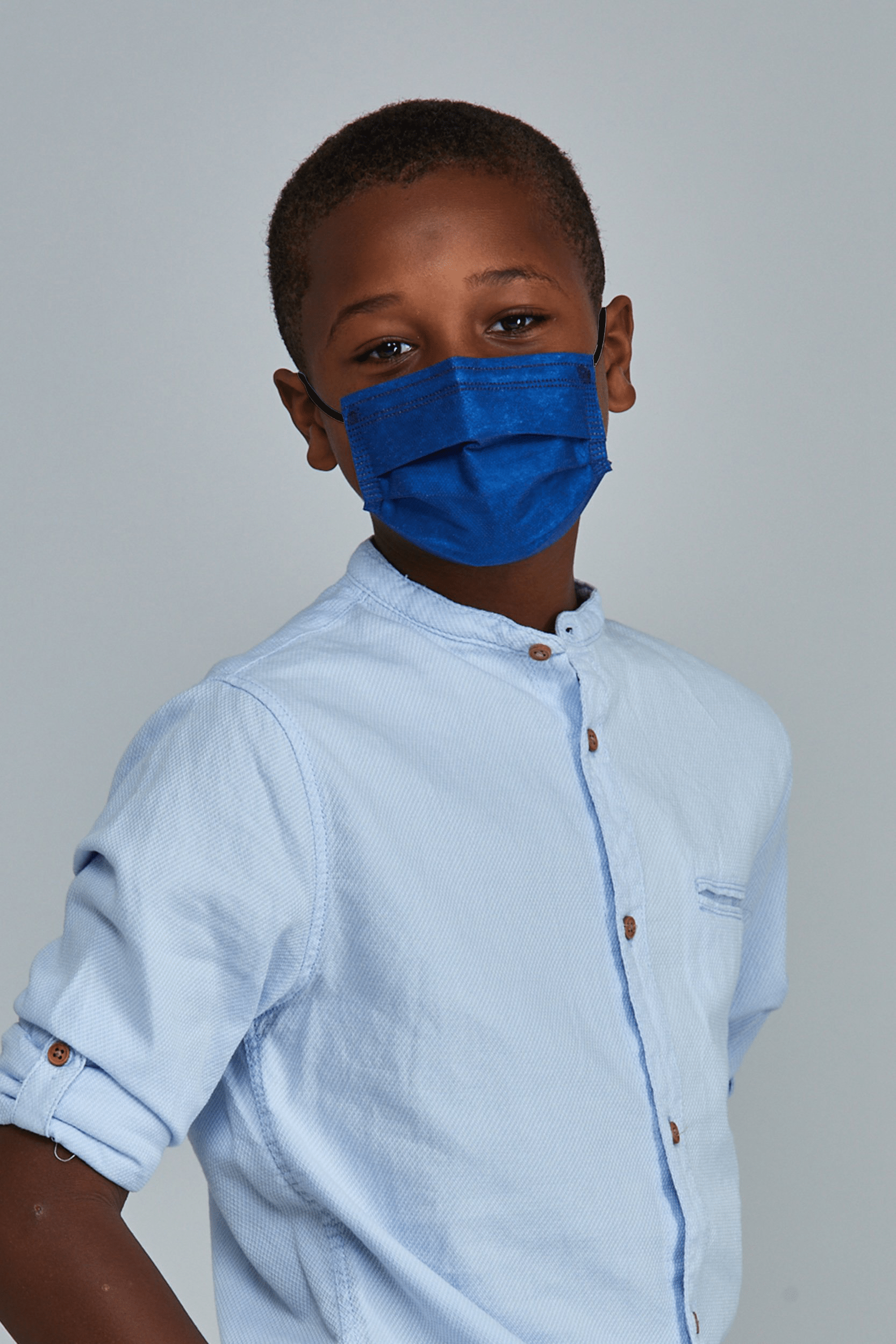 Child wearing stylish Navy Blue Pleated face mask, with three layers & high quality breathable fabric.