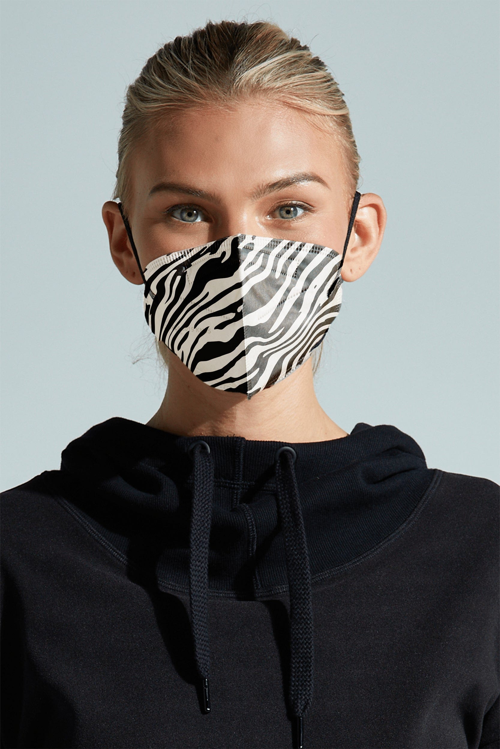 Woman wearing stylish Zebra KN95 face mask, with high quality breathable fabric. 