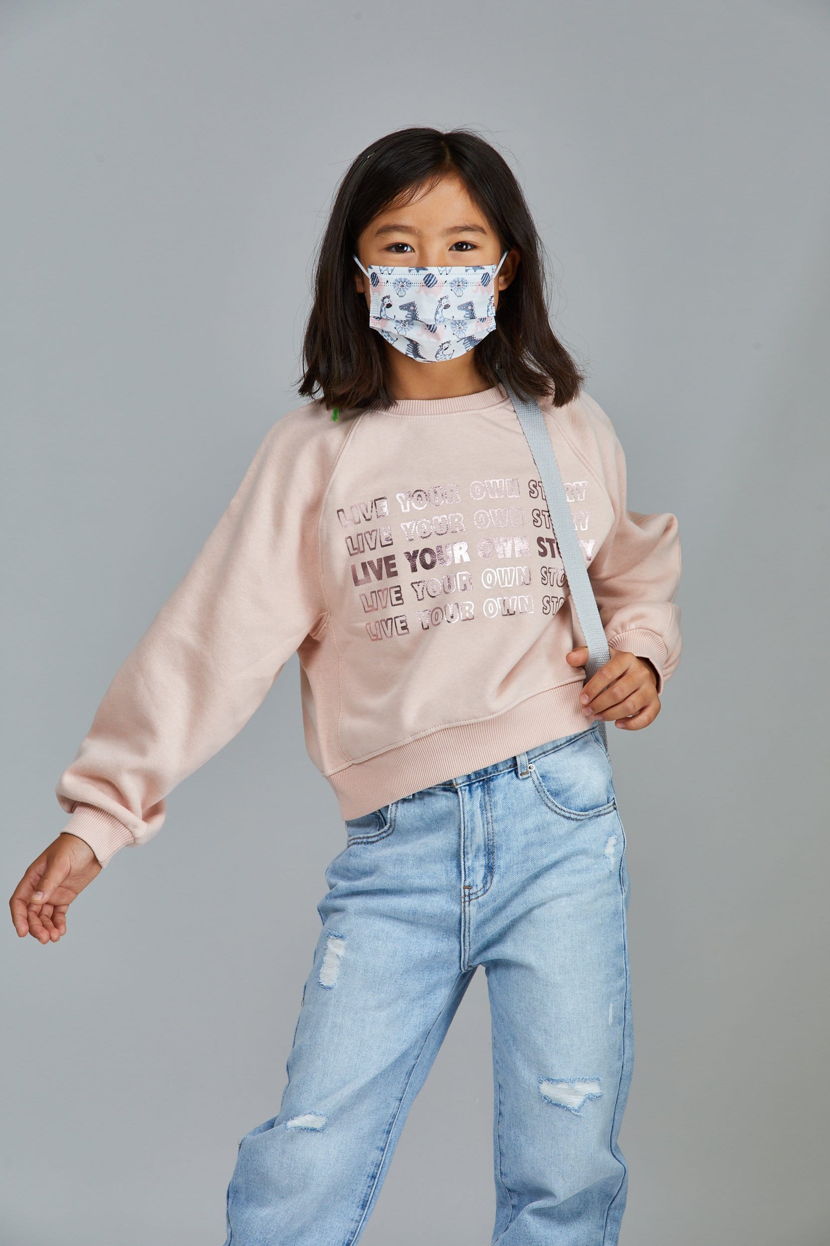 Child wearing stylish Animal Themed (Dinosaurs, Lions, Giraffes) Themed Pleated face mask, with three layers & high quality breathable fabric. 
