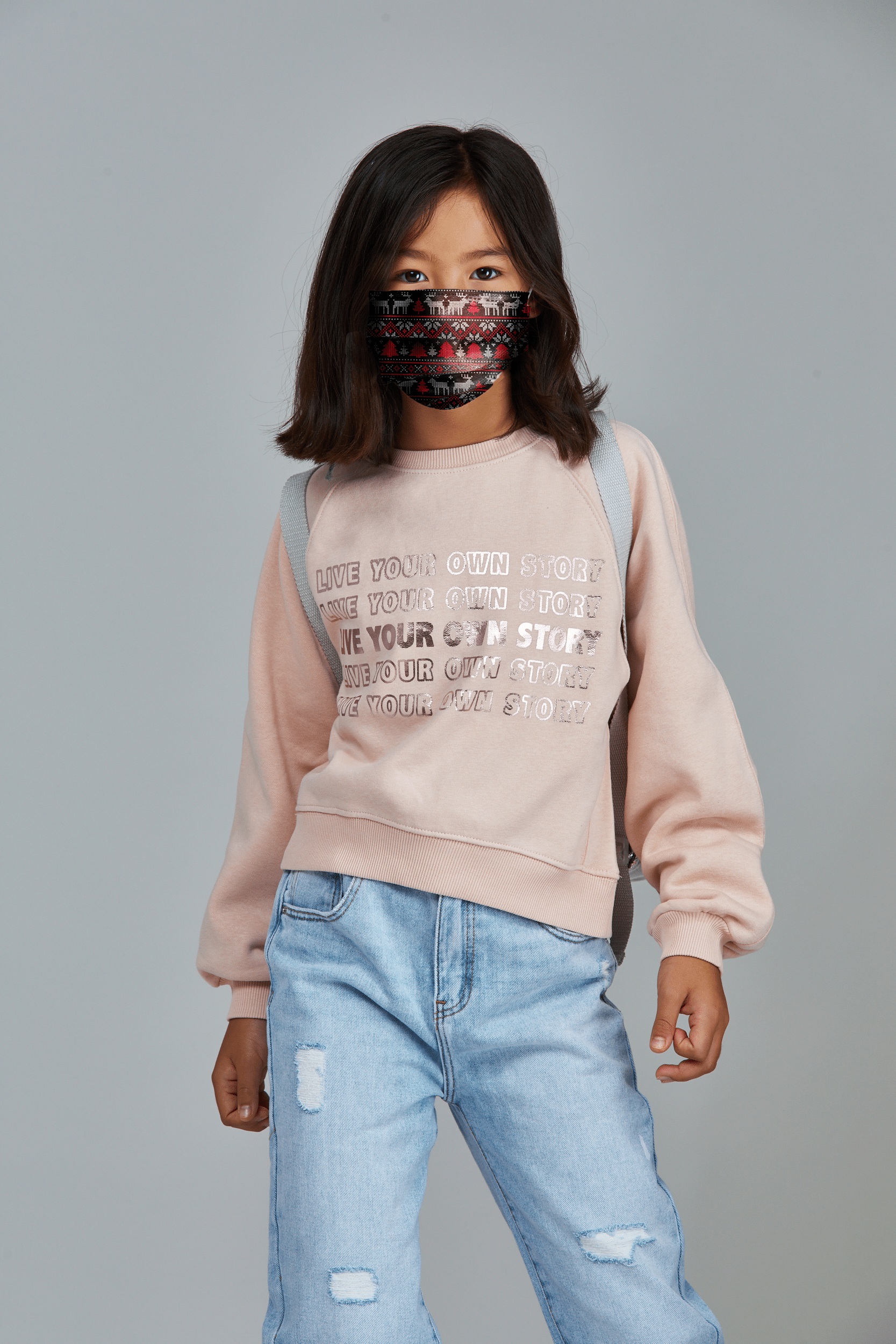 Child wearing stylish Christmas/Holiday Themed Pleated face mask, with three layers & high quality breathable fabric. 
