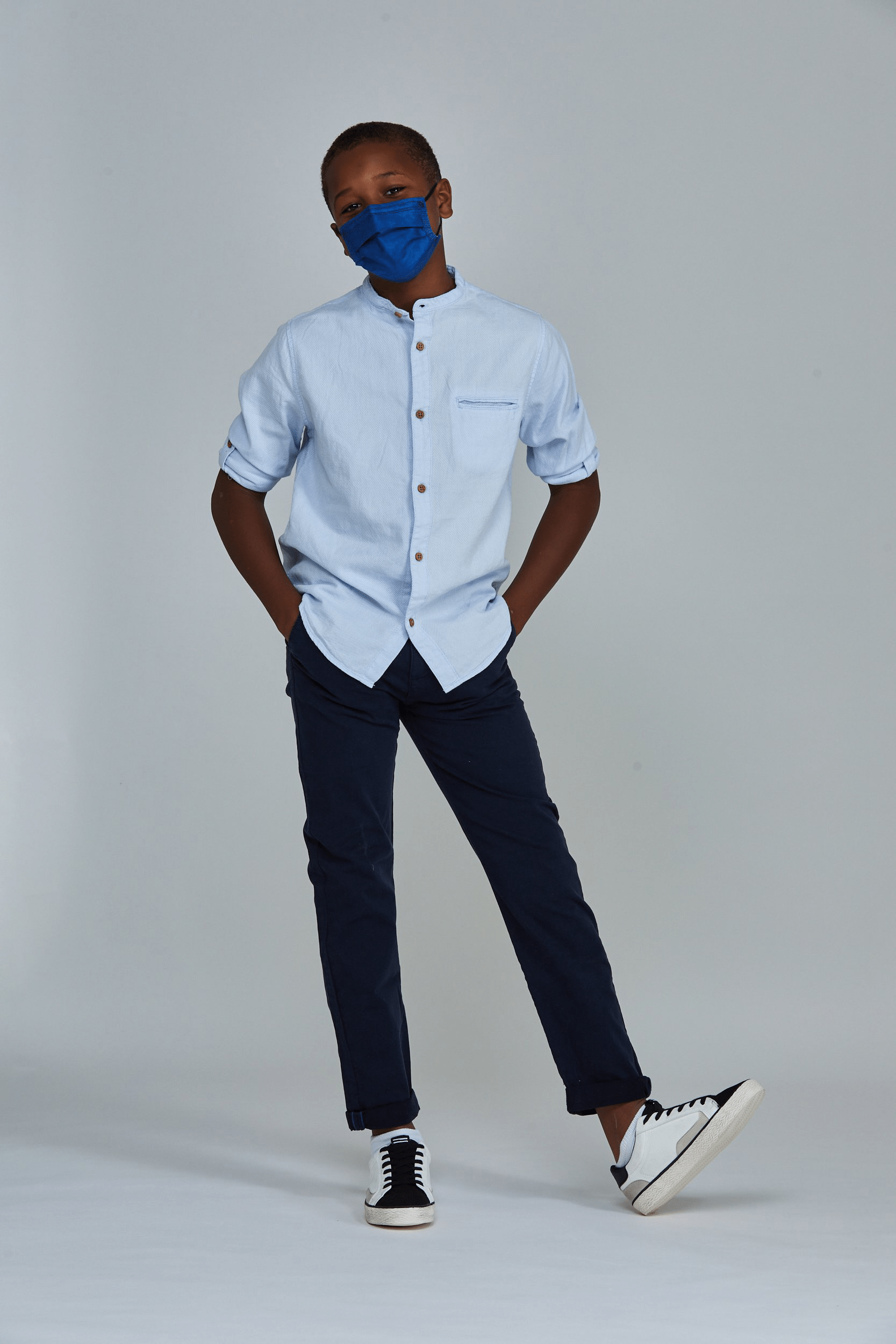 Child wearing stylish Navy Blue  Pleated face mask, with three layers & high quality breathable fabric. 